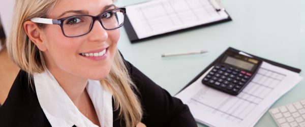 Young Businesswoman Calculating Data In Her Office